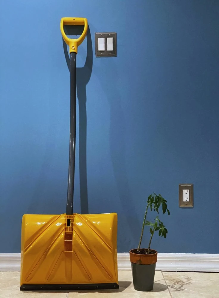 Yellow Shovel Blue Wall