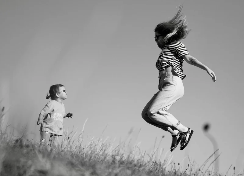 Playful Mother Daughter Jump