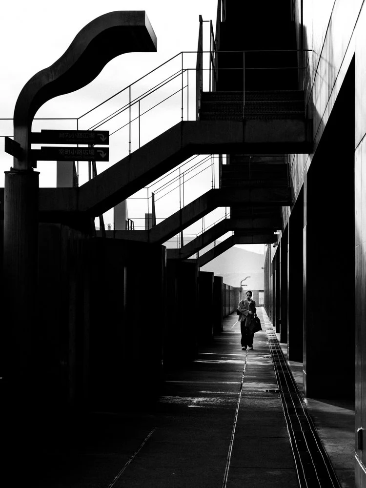 Figure on Shadowed Walkway