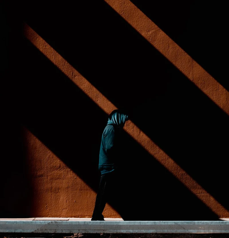 Hooded Man in Shadows