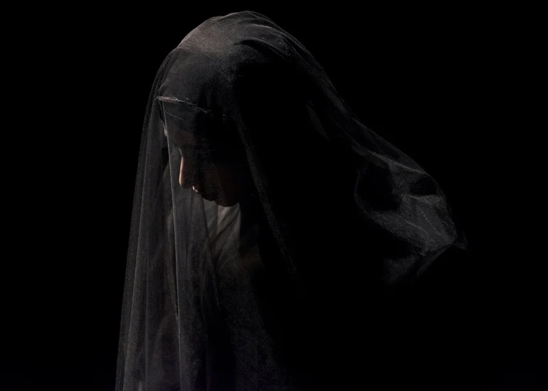 Solemn Veiled Woman