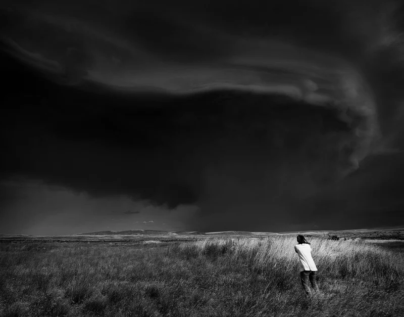 Figure Under Stormy Sky