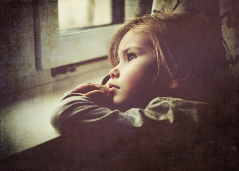 Pensive Child At Window