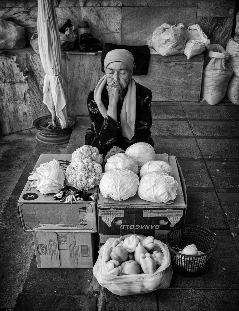 Pensive Market Vendor
