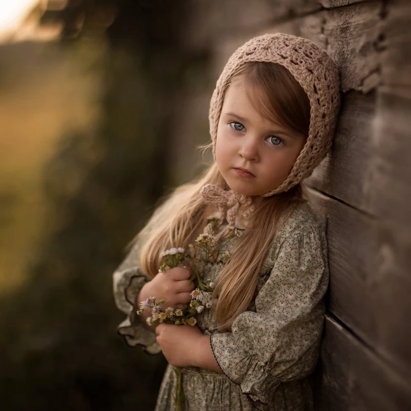 Pensive Girl Holding Flowers