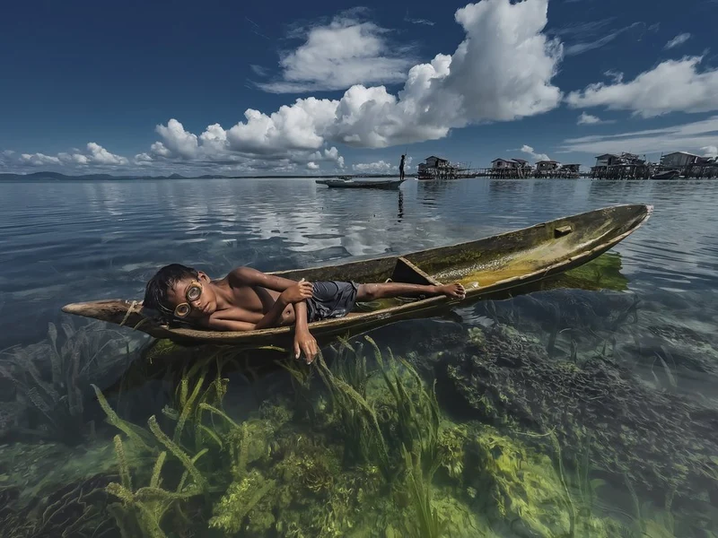 Boy Floating In Clear Water