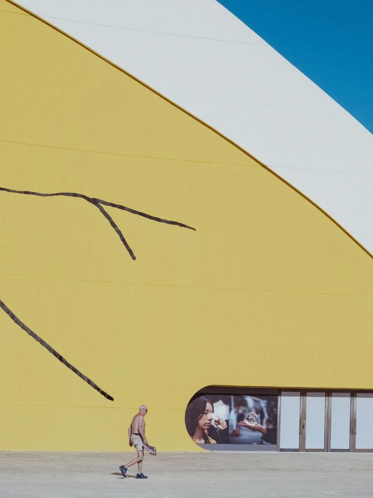 Man Walks Yellow Wall