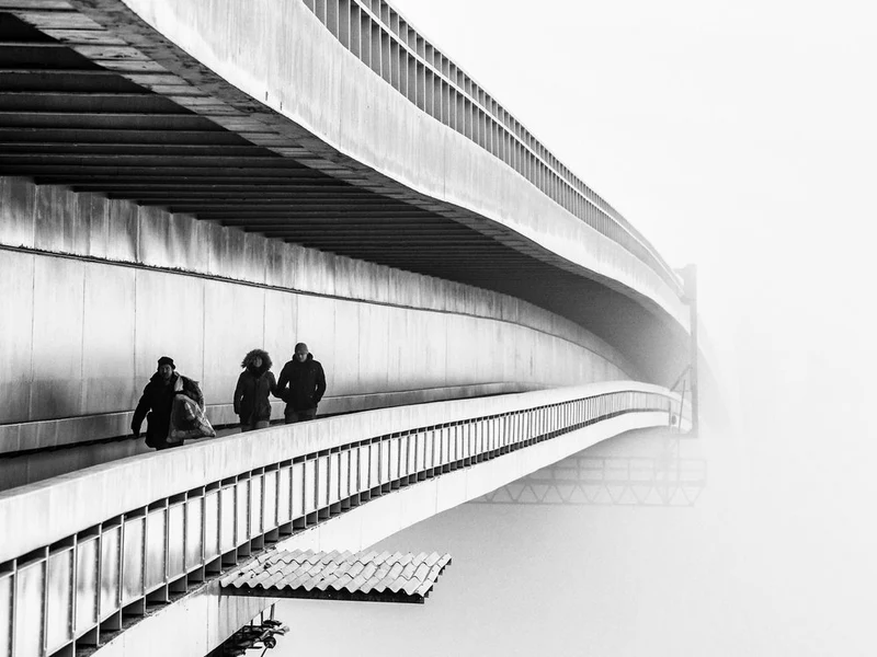 Figures On Foggy Bridge