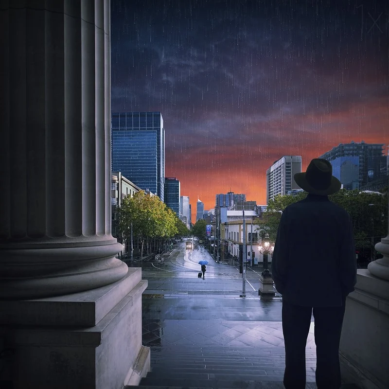 Man Overlooking Rainy City