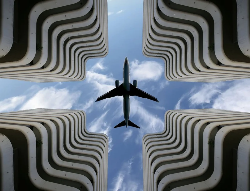 Airplane Over Urban Architecture