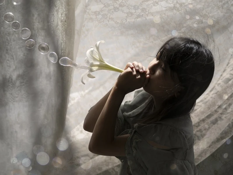 Girl Blowing Lily Bubbles
