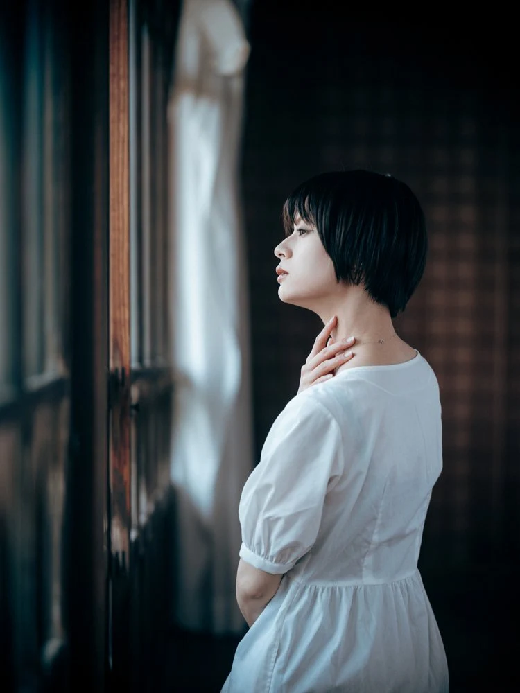 Thoughtful Woman By Window