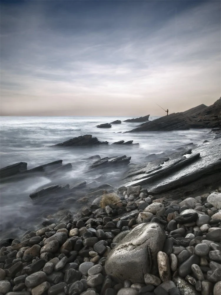 Misty Coastline Fisherman