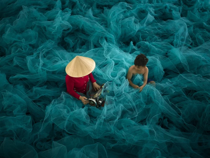 a mother and child on a green net