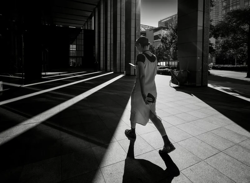 Woman in City Shadows