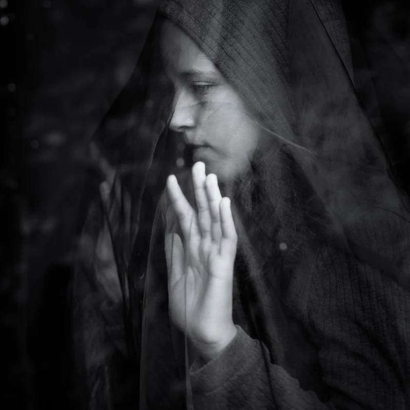 Pensive Hooded Woman