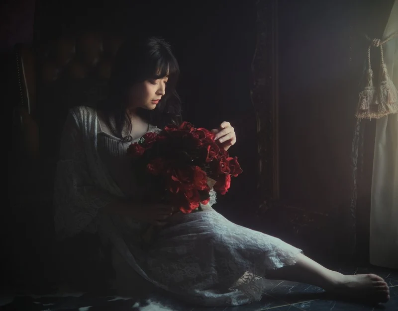 Pensive Woman Red Flowers
