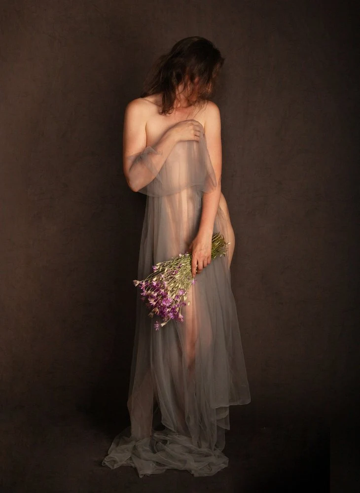 Ethereal Woman Holding Flowers