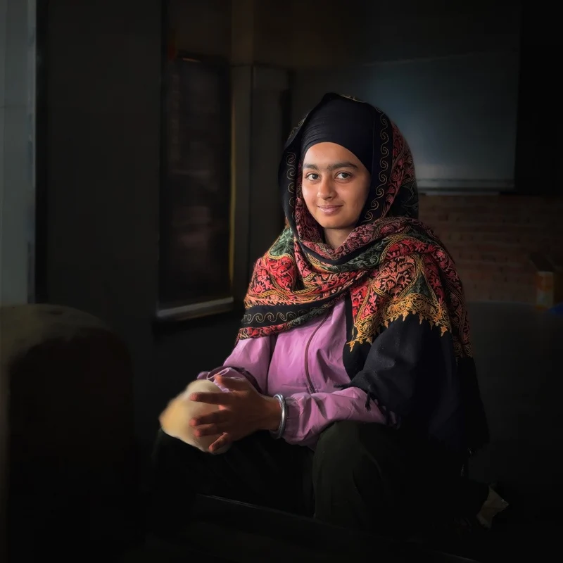 A girl with a Mona Lisa-like smile making naan